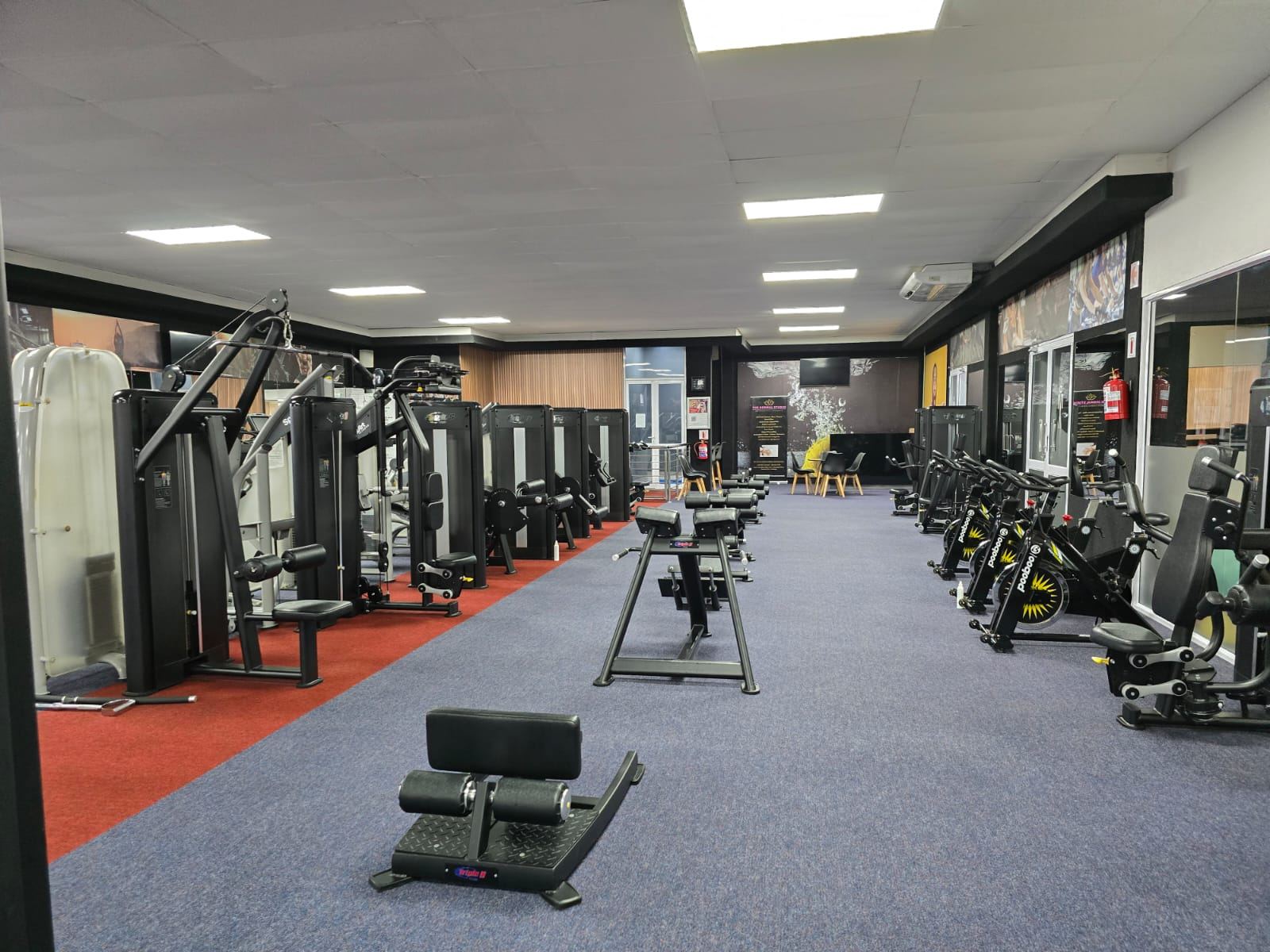 Wide view of the Triple S gym floor with strength machines
