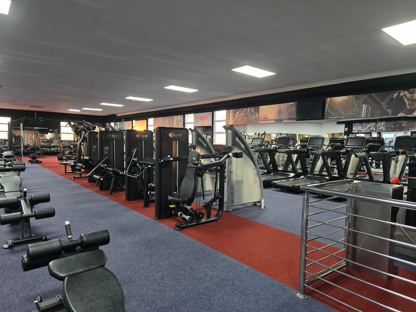 Row of strength machines on the red turf