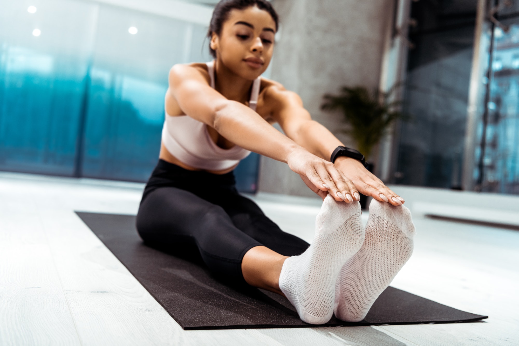 Beautiful sportive girl stretching in fitness gym